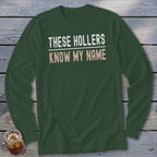 Green long-sleeved shirt with text "THESE HOLLERS KNOW MY NAME".