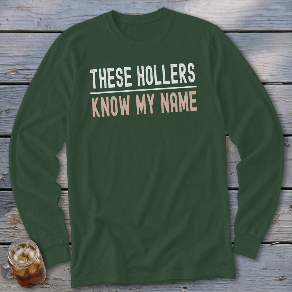 Green long-sleeved shirt with text "THESE HOLLERS KNOW MY NAME".