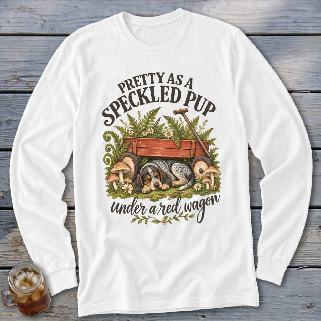 Dog sleeping in red wagon under ferns with text "Pretty as a Speckled Pup"