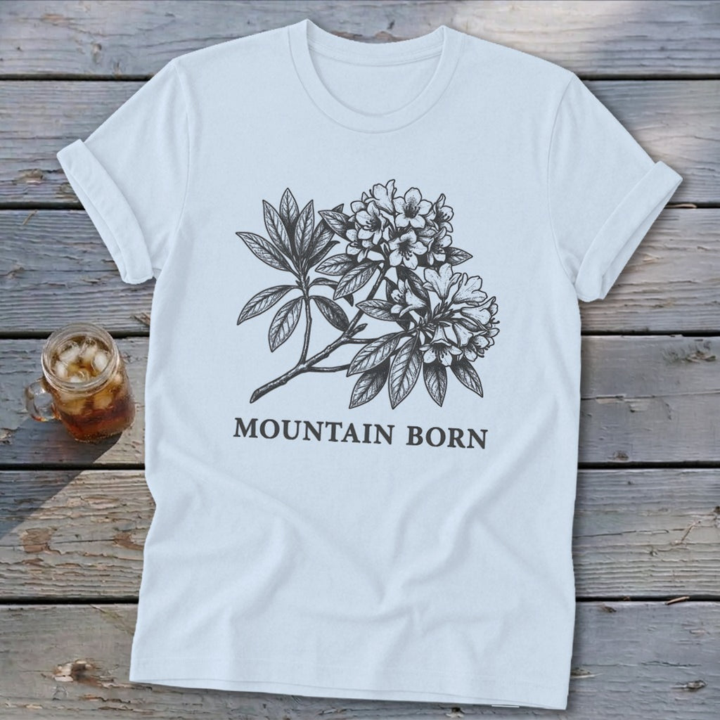 Light blue t-shirt with black sketch of mountain laurel and "MOUNTAIN BORN" text.