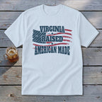 White t-shirt with "Virginia Raised American Made" text and distressed US flag graphic.