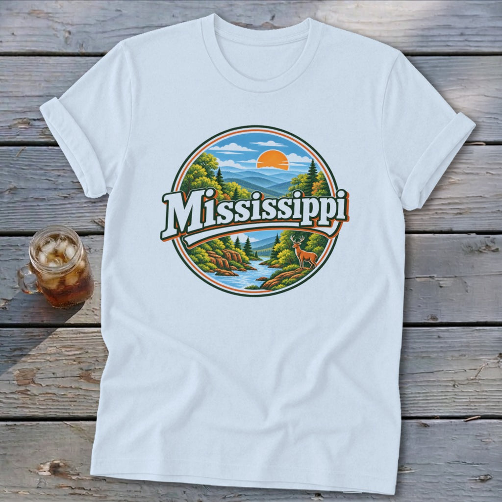 White t-shirt with circular graphic featuring "Mississippi" text, mountains, river, trees, and deer.