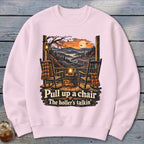 Two rocking chairs on a porch with pumpkins and text "Pull up a chair, the holler's talkin'".