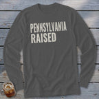 Dark grey long-sleeve shirt with white "PENNSYLVANIA RAISED" text.