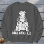 Dark gray sweatshirt with white graphic of a seated boy holding a bucket and the text "COAL CAMP KID".