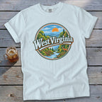 White t-shirt with "West Virginia" circular graphic of mountains, river, deer, and sun.