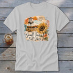 Graphic t-shirt with water tower, sunflower, and "Small Town Fall Vibes" text.