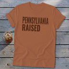 Orange t-shirt with "PENNSYLVANIA RAISED" text.