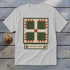 White t-shirt featuring a green "Bear's Paw" quilt block design with text.