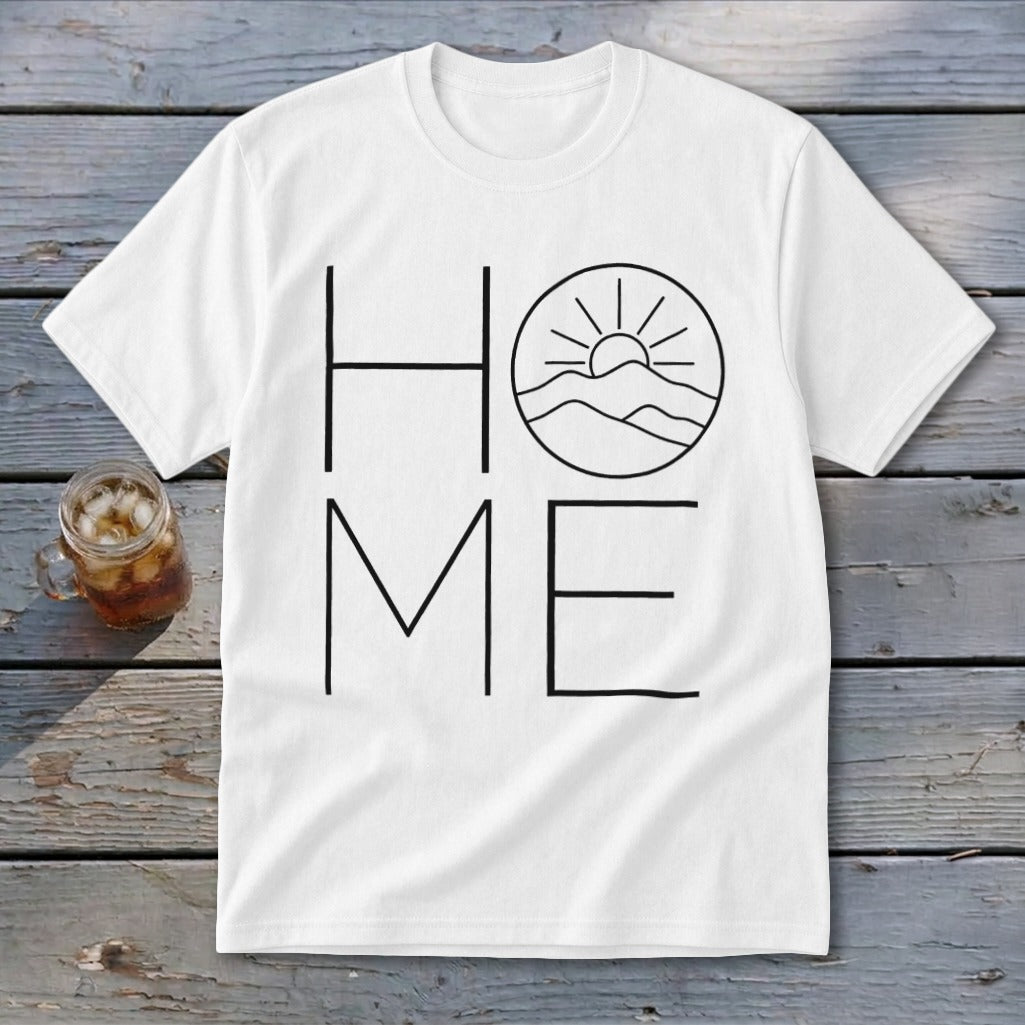 A white crewneck t-shirt featuring the word HOME in black line art, with a mountain and sun graphic replacing the letter O.