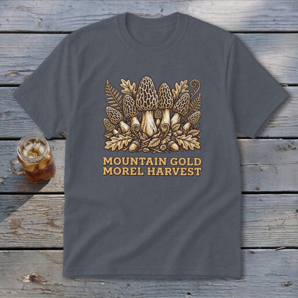 A dark gray t-shirt featuring a yellow graphic of morel mushrooms, leaves, and text reading MOUNTAIN GOLD MOREL HARVEST.