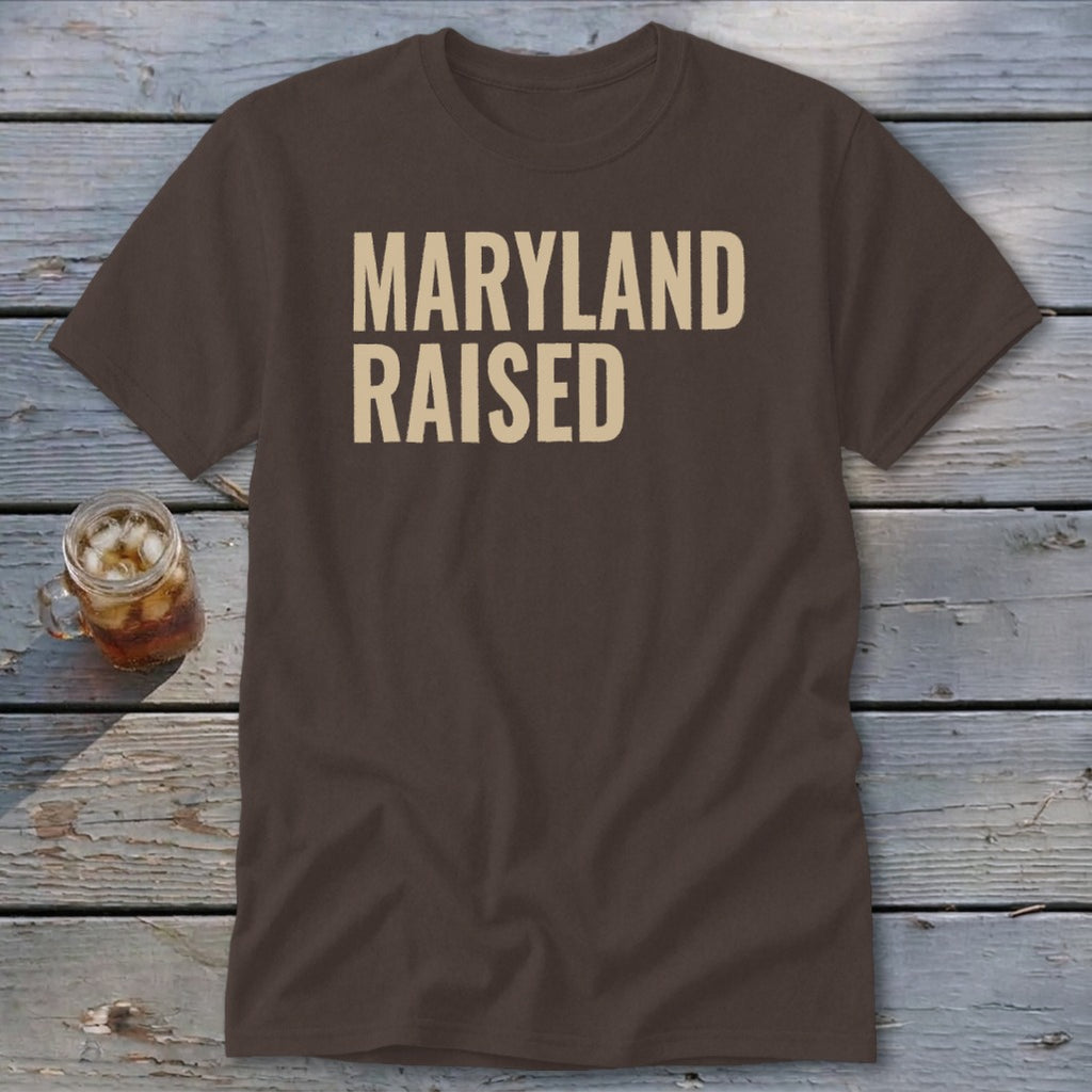 Brown t-shirt with "MARYLAND RAISED" text and a drink in a mug.