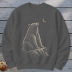 Dark gray sweatshirt with a bear sitting on a rock looking at a crescent moon and stars.