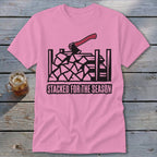 Pink t-shirt with black graphic of stacked firewood, axe, and text "STACKED FOR THE SEASON".