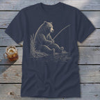 Bear sitting by the water, holding a fishing rod, on a navy t-shirt.