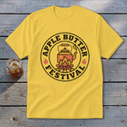 Yellow t-shirt with "Apple Butter Festival" text and kettle over campfire graphic.
