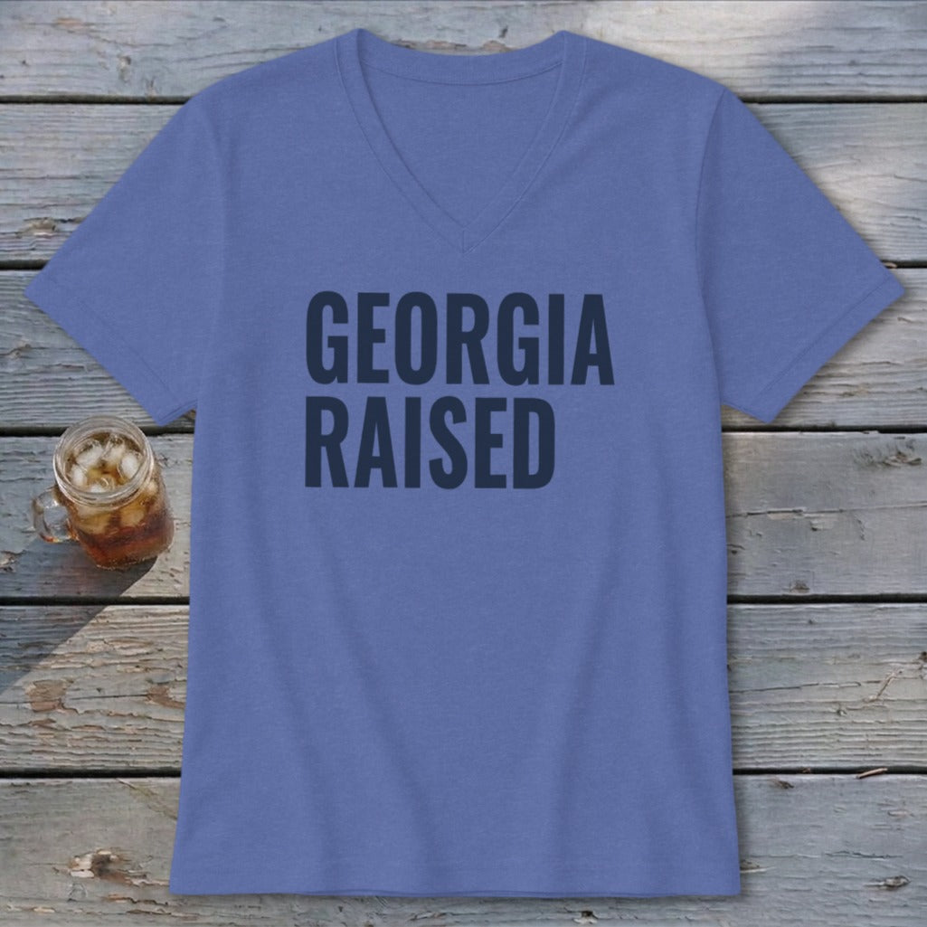 Blue v-neck t-shirt with "GEORGIA RAISED" text and a glass of iced tea.