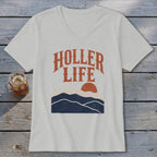 A light grey V-neck t-shirt featuring the text HOLLER LIFE above a retro mountain sunset graphic.