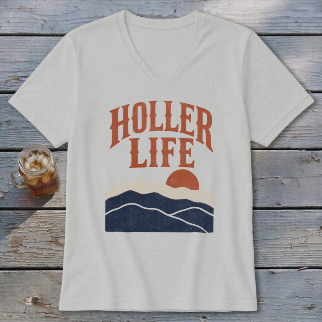 A light grey V-neck t-shirt featuring the text HOLLER LIFE above a retro mountain sunset graphic.