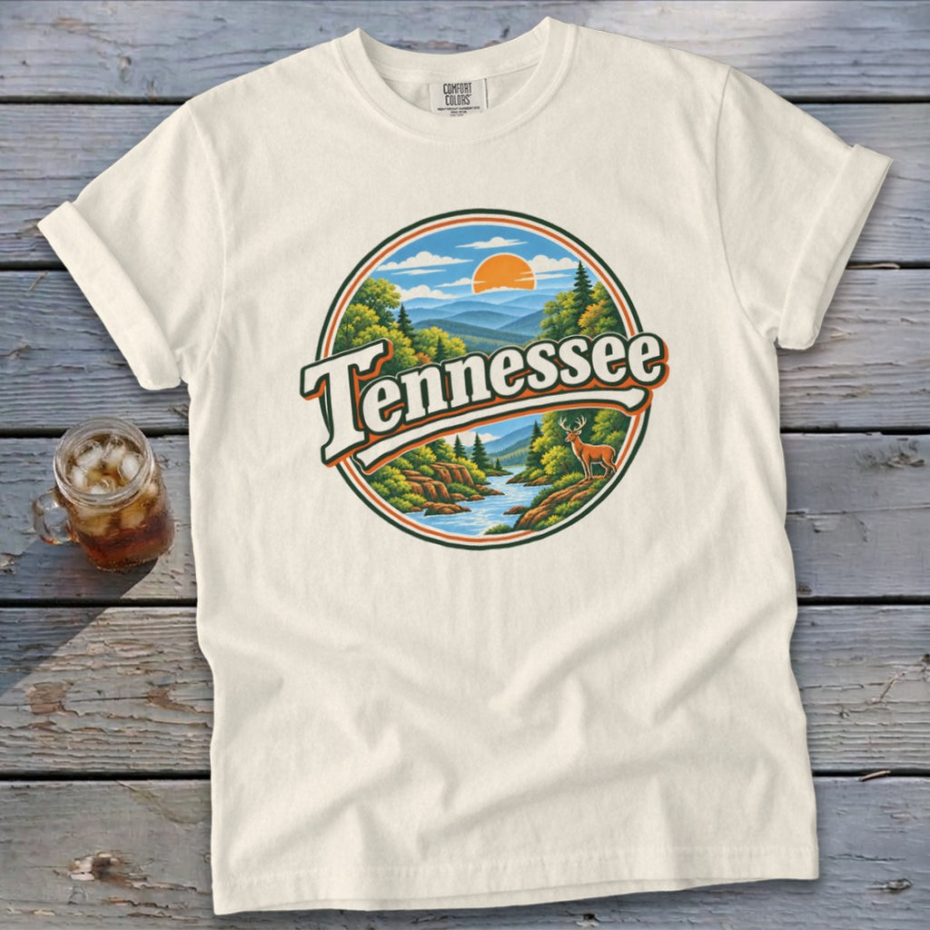 Cream t-shirt with circular Tennessee graphic featuring mountains, river, and deer.