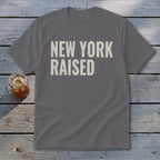 Gray t-shirt with "NEW YORK RAISED" text in cream.