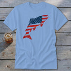 Light blue short-sleeve t-shirt featuring a leaping fish graphic patterned with the American flag.