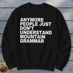 Black sweatshirt with white text reading "Anymore people just don't understand mountain grammar."