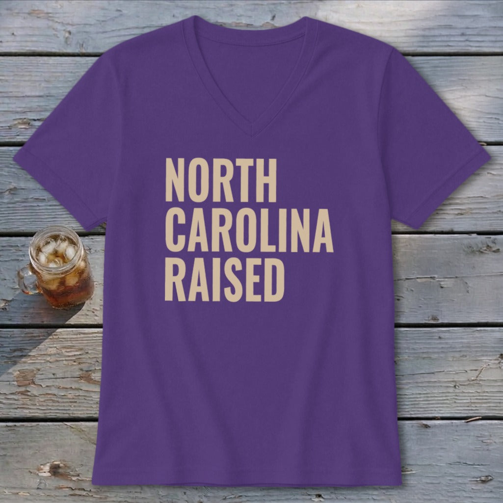 Purple v-neck t-shirt with "NORTH CAROLINA RAISED" text in tan.