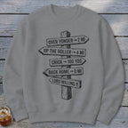 A grey crewneck sweatshirt featuring a black graphic of a wooden signpost with directional text.