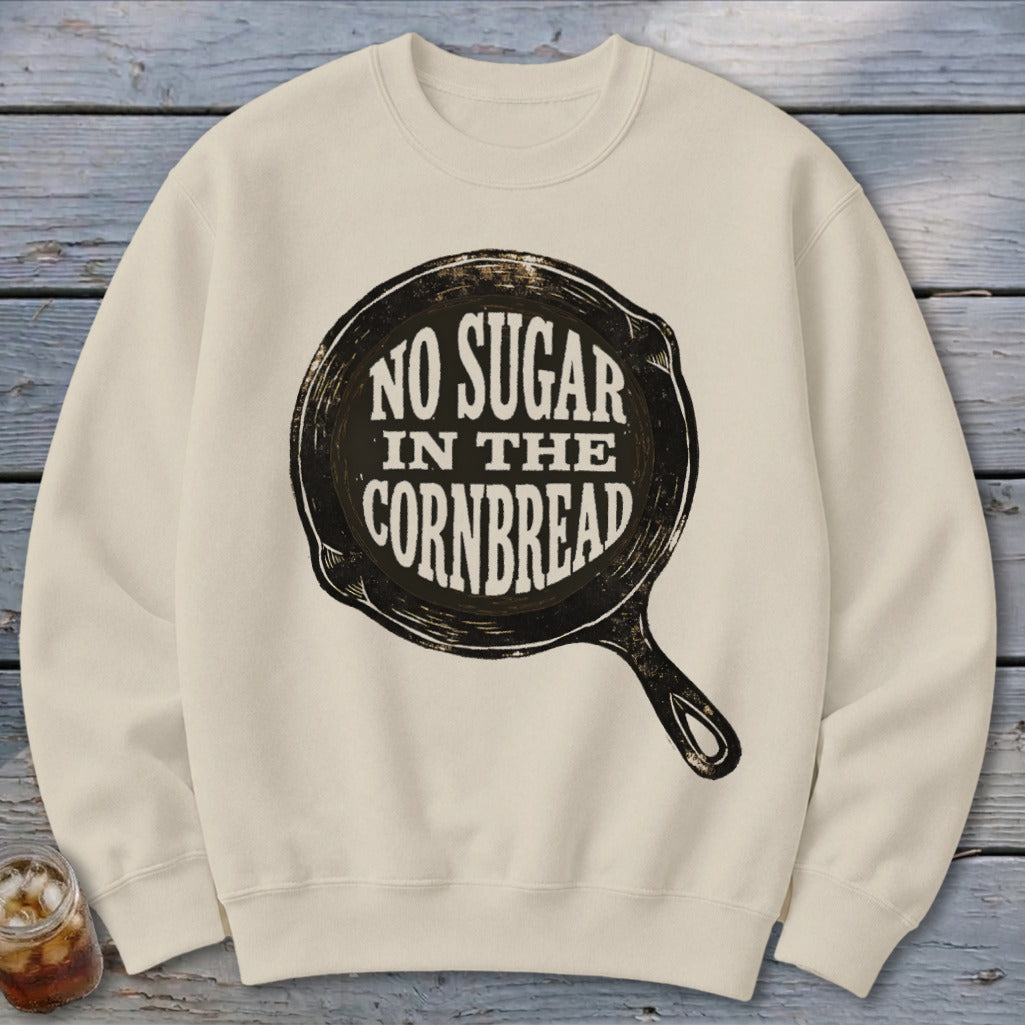 Cream sweatshirt with black text "NO SUGAR IN THE CORNBREAD" inside a skillet graphic.