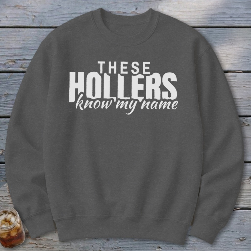 Dark grey sweatshirt with white text that reads "THESE HOLLERS know my name."