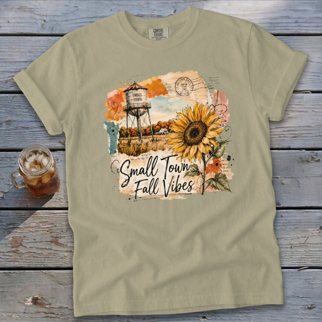T-shirt with "Small Town Fall Vibes" graphic featuring a water tower and sunflower.