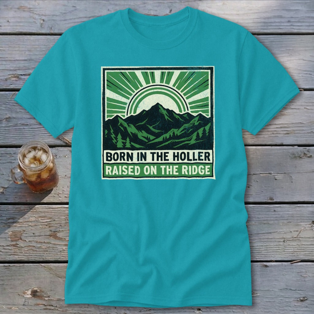 Teal crewneck t-shirt featuring a green graphic of mountains, trees, and the text Born in the Holler, Raised on the Ridge.