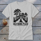 White t-shirt with black graphic of a house, trees, fence, and text "OLD HOME PLACE".
