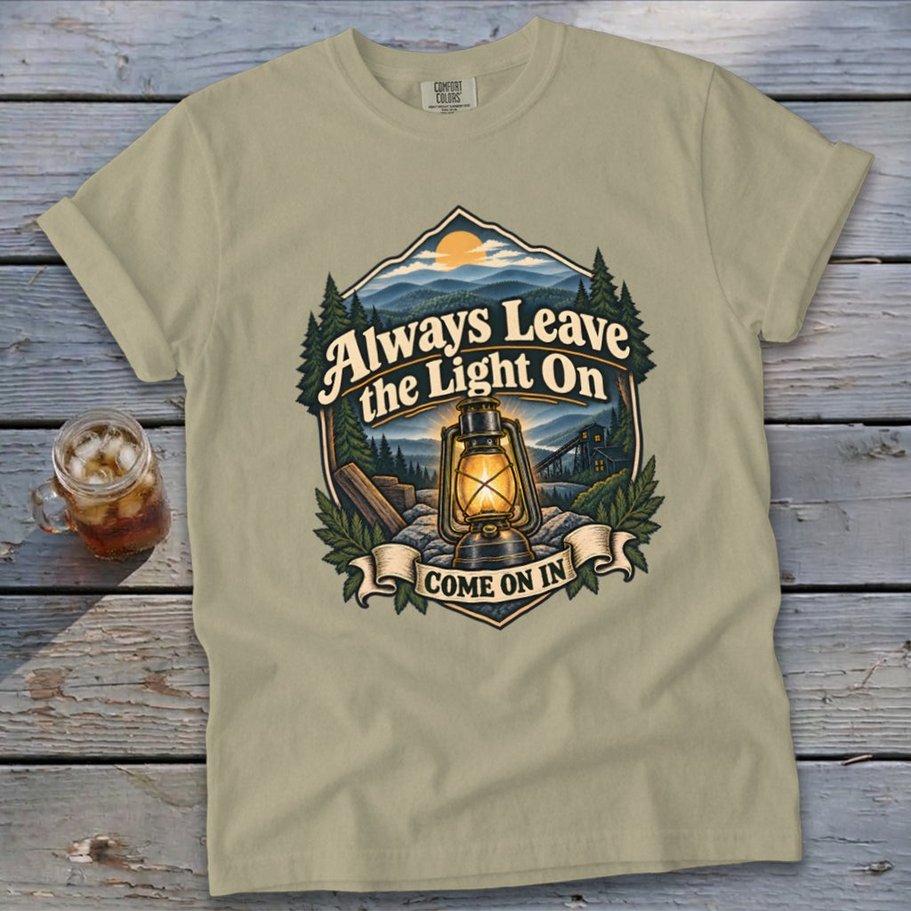 Light tan t-shirt with graphic: "Always Leave the Light On. Come On In."