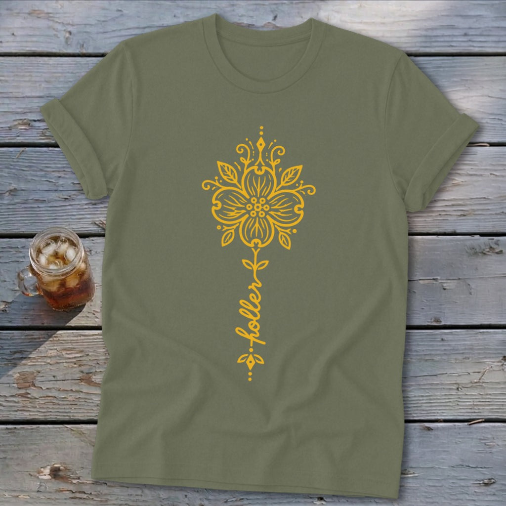 Olive t-shirt with a yellow ornate floral design and "holler" text.