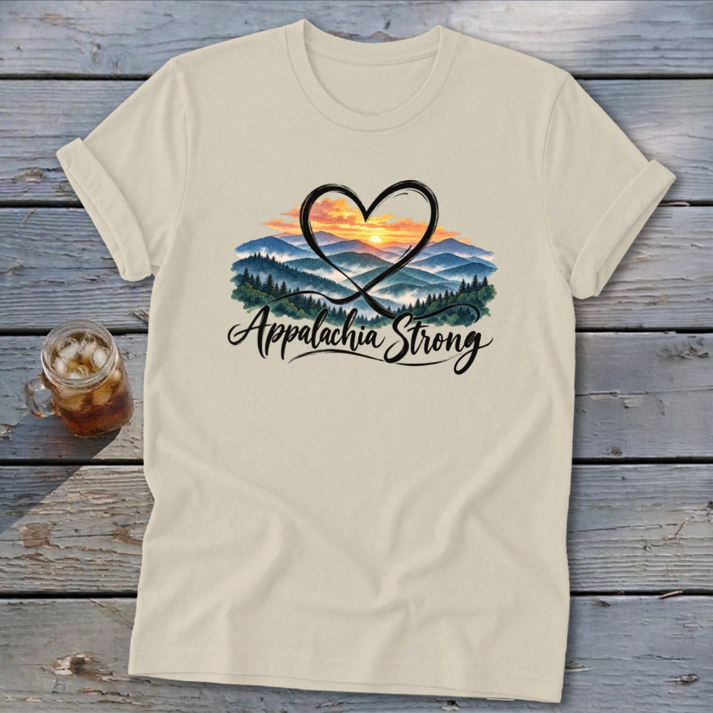 Cream t-shirt with "Appalachia Strong" text and a heart framing a mountain sunset scene.