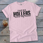 Pink t-shirt with black text that reads "THESE HOLLERS know my name."