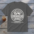 Dark gray t-shirt featuring a circular white graphic with a cornbread illustration and the text CERTIFIED CORNBREAD JUDGE.