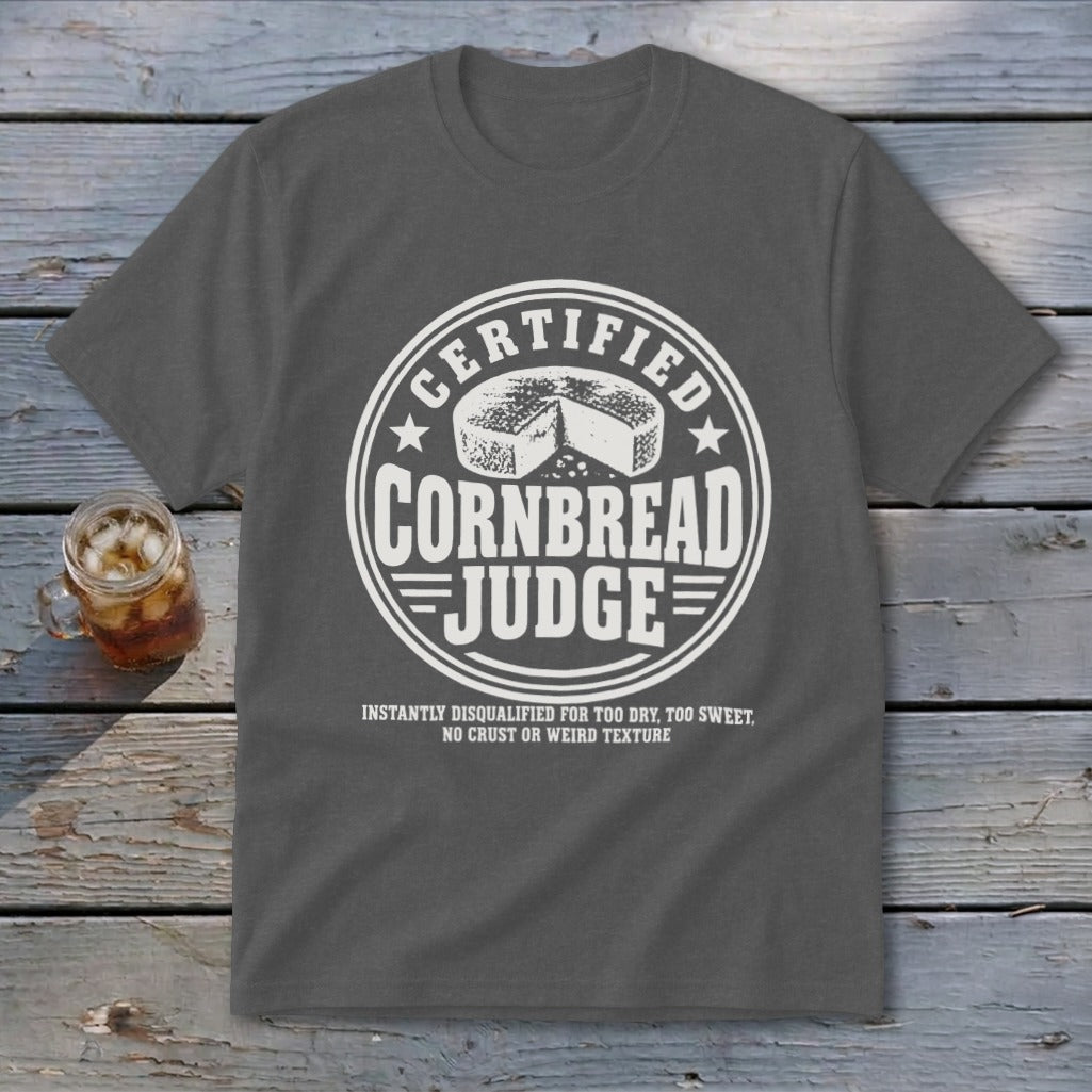 Dark gray t-shirt featuring a circular white graphic with a cornbread illustration and the text CERTIFIED CORNBREAD JUDGE.