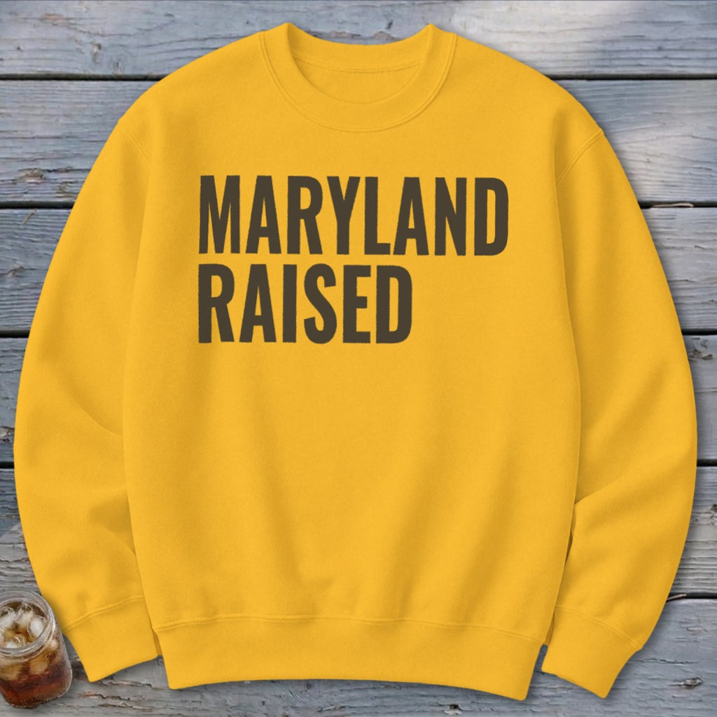 Yellow crewneck sweatshirt with bold black text reading "MARYLAND RAISED".