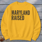 Yellow crewneck sweatshirt with bold black text reading "MARYLAND RAISED".