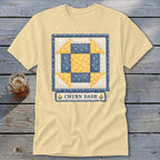 Pale yellow t-shirt with a "Churn Dash" quilt block design and text.