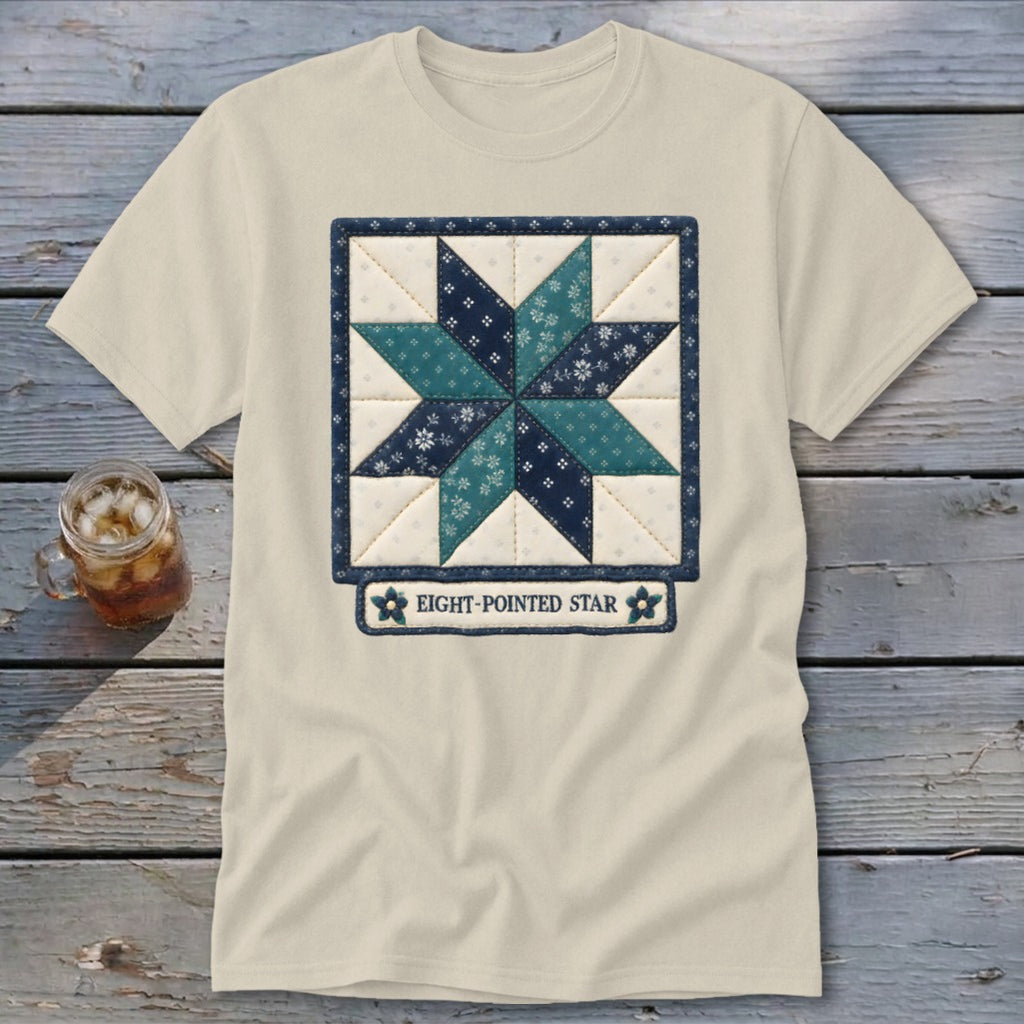 Light t-shirt with an embroidered eight-pointed star quilt design and text.