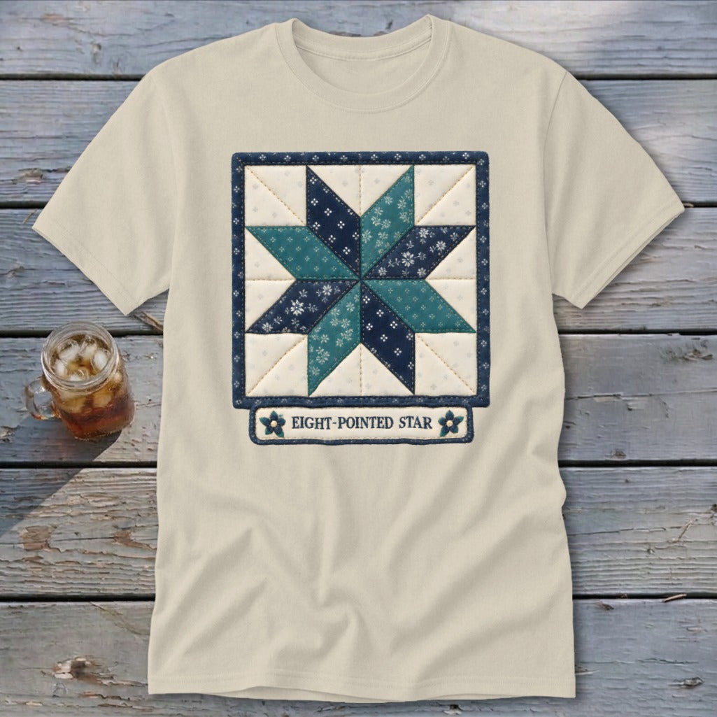 Light t-shirt with an embroidered eight-pointed star quilt design and text.