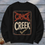 Black sweatshirt with distressed "CRICK CREEK" sign graphic, red cross-out, and checkmark.