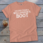 Peach t-shirt with white text reading "Colder Than A Welldigger's Boot".