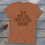 Orange t-shirt with "WE SPEAK MOUNTAIN HERE" text in dark brown.