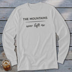 White long sleeve shirt with black text that reads "THE MOUNTAINS never left me."