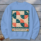 Light blue sweatshirt with a quilted "Drunkard's Path" block design and text.